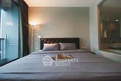 Cozy bedroom with modern decor and large window for natural light