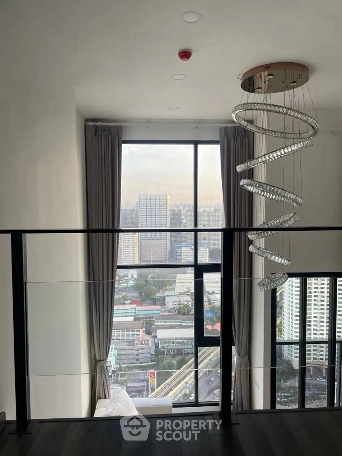 Stunning high-rise apartment with floor-to-ceiling windows and city view.