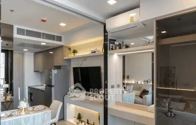 Modern open-plan living room with stylish kitchen and dining area, featuring sleek appliances and elegant decor.