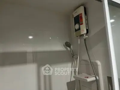 Modern bathroom with sleek shower and water heater, perfect for comfort and convenience.