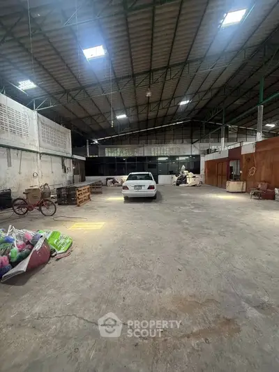 Spacious industrial warehouse with high ceilings and ample storage space.
