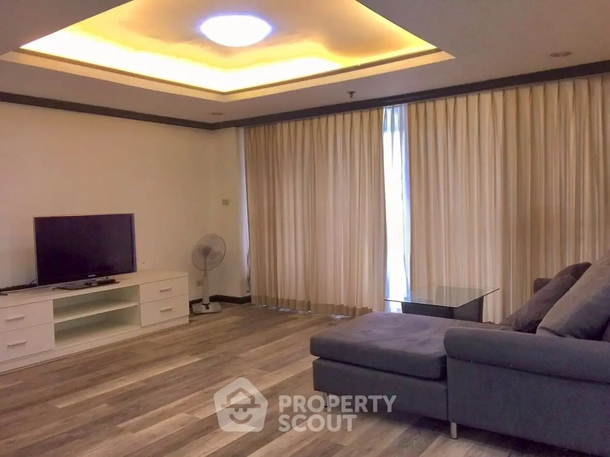 Spacious living room with modern decor and large windows for natural light.