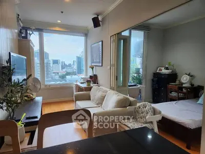 Modern living room with city view, cozy seating, and natural light