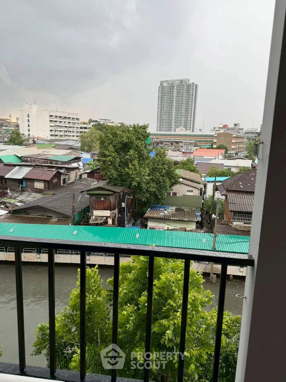 Stunning urban view from balcony overlooking cityscape and river, perfect for serene living.