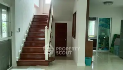 Spacious interior with elegant wooden staircase and modern design