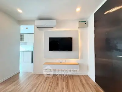 Modern living room with sleek TV setup and wooden flooring
