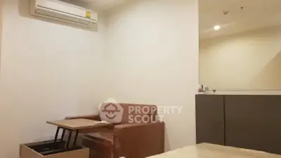 Modern living room with sofa, air conditioner, and stylish table in cozy apartment.