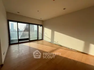 Spacious empty room with large windows and city view, perfect for customization.