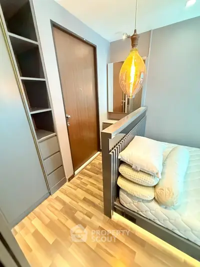 Modern compact bedroom with stylish lighting and wooden flooring