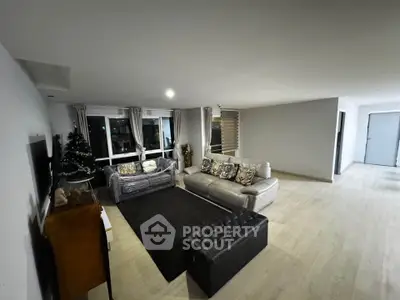 Spacious modern living room with elegant decor and large windows