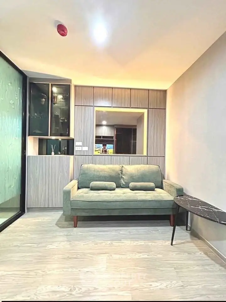 Modern living room with stylish sofa and sleek cabinetry in a contemporary apartment.