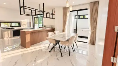 Luxurious open-plan kitchen and dining area with marble flooring and modern lighting.