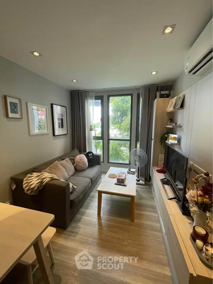 Cozy living room with modern decor and large window view.