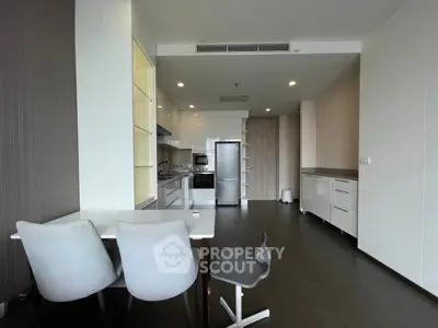 Modern kitchen with sleek design, featuring open layout and stylish furniture.
