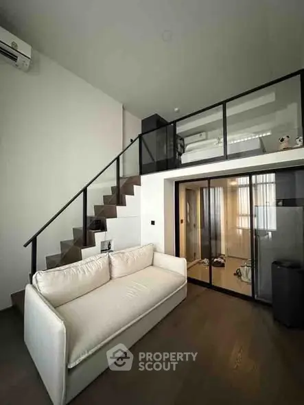 Modern loft apartment with mezzanine bedroom and sleek interior design.