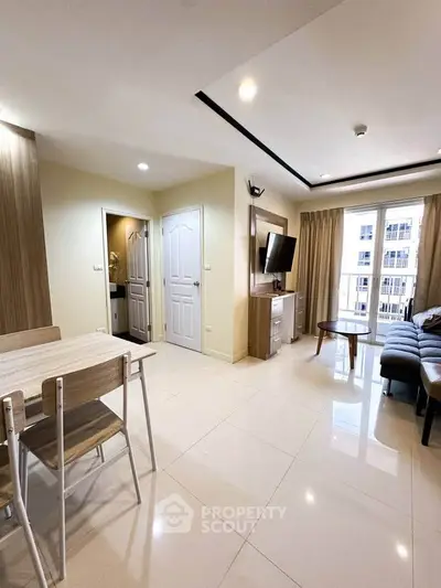 Modern living room with sleek furniture and natural light in a stylish apartment.