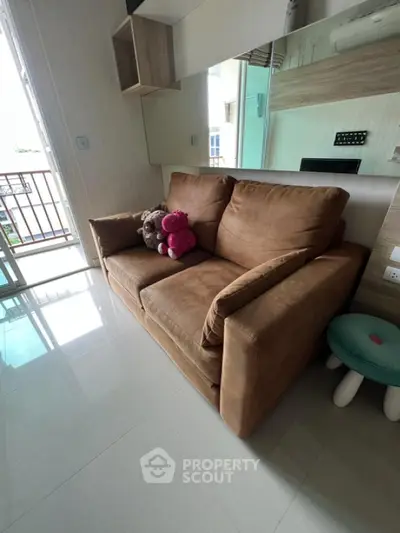 Cozy living room with plush brown sofa and balcony view