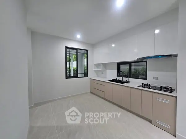 Modern kitchen with sleek cabinetry and gas stove in a bright, spacious layout.