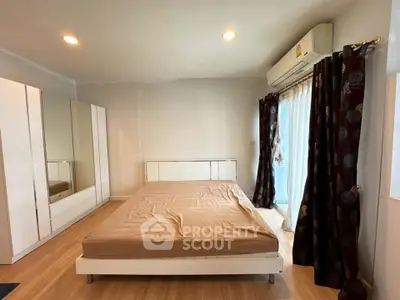 Spacious bedroom with modern furniture and natural light
