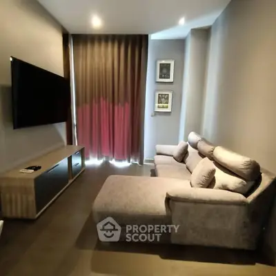 Modern living room with cozy sectional sofa and wall-mounted TV, ideal for relaxation.