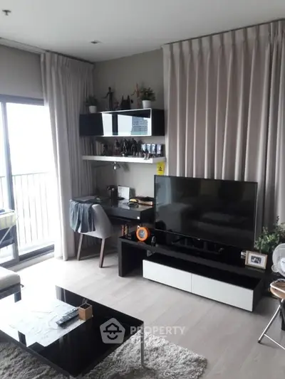 Modern living room with sleek furniture and balcony view, perfect for urban living.