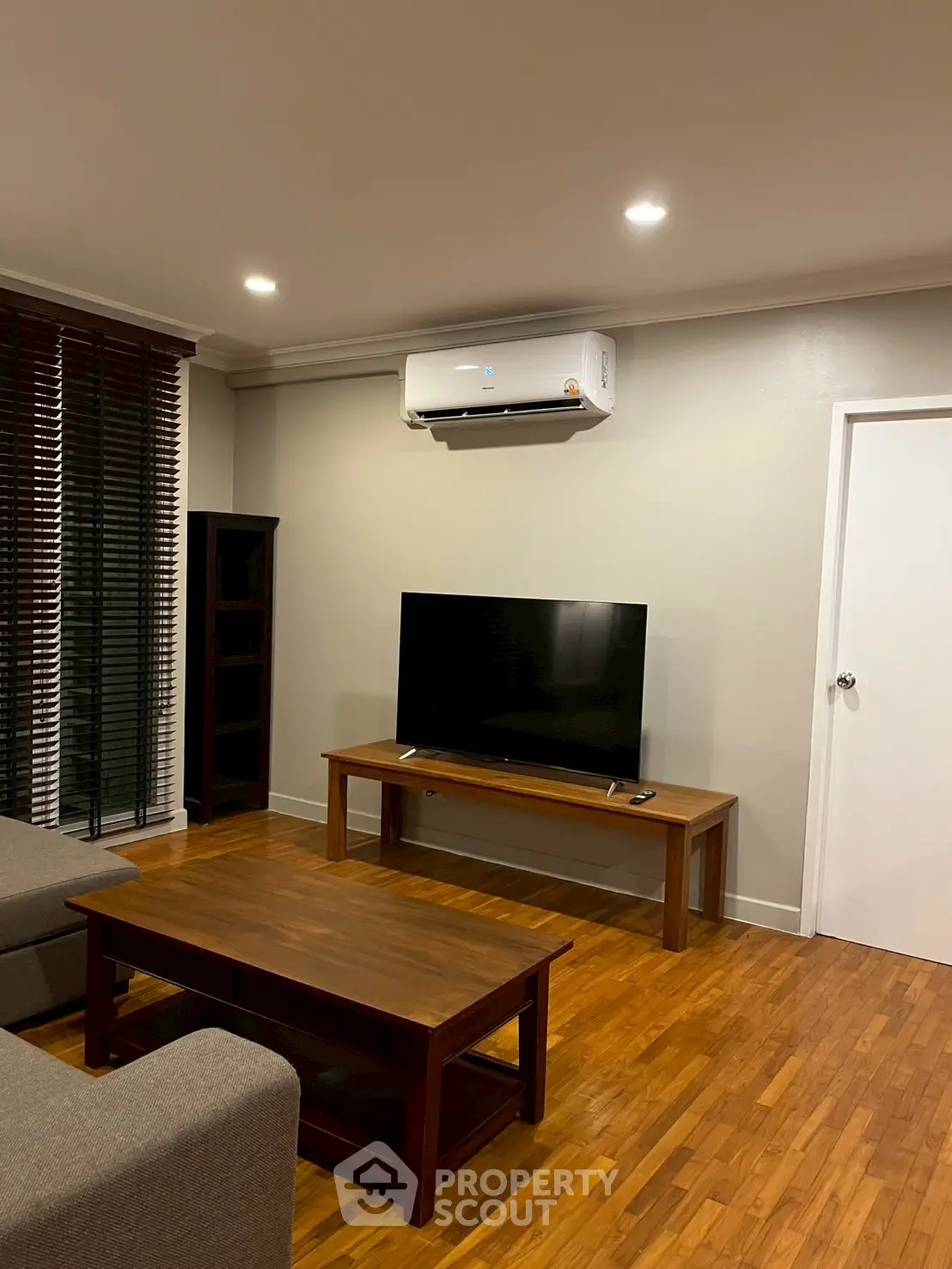 Cozy living room with modern TV setup and air conditioning