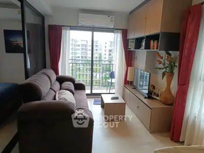 Modern living room with cozy sofa, TV unit, and balcony view in stylish apartment.