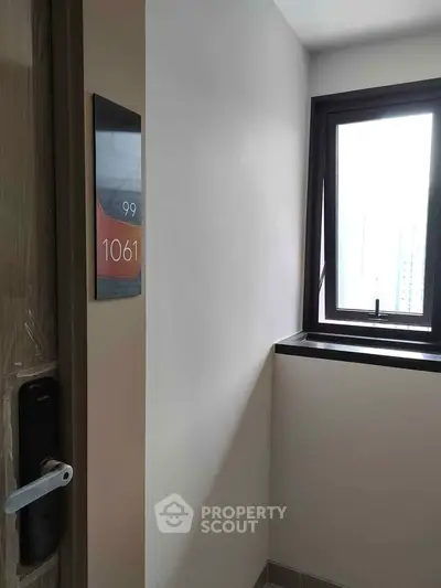 Modern apartment entrance with digital lock and window view
