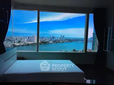Stunning bedroom with panoramic city and river view, featuring large windows and modern design.