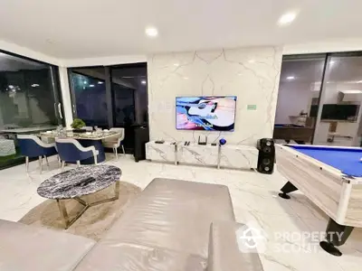 Luxurious living room with marble accents, modern furniture, and entertainment area.