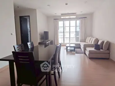 Spacious living room with modern furniture and large windows offering natural light.