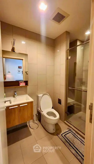 Modern bathroom with sleek fixtures and glass shower enclosure