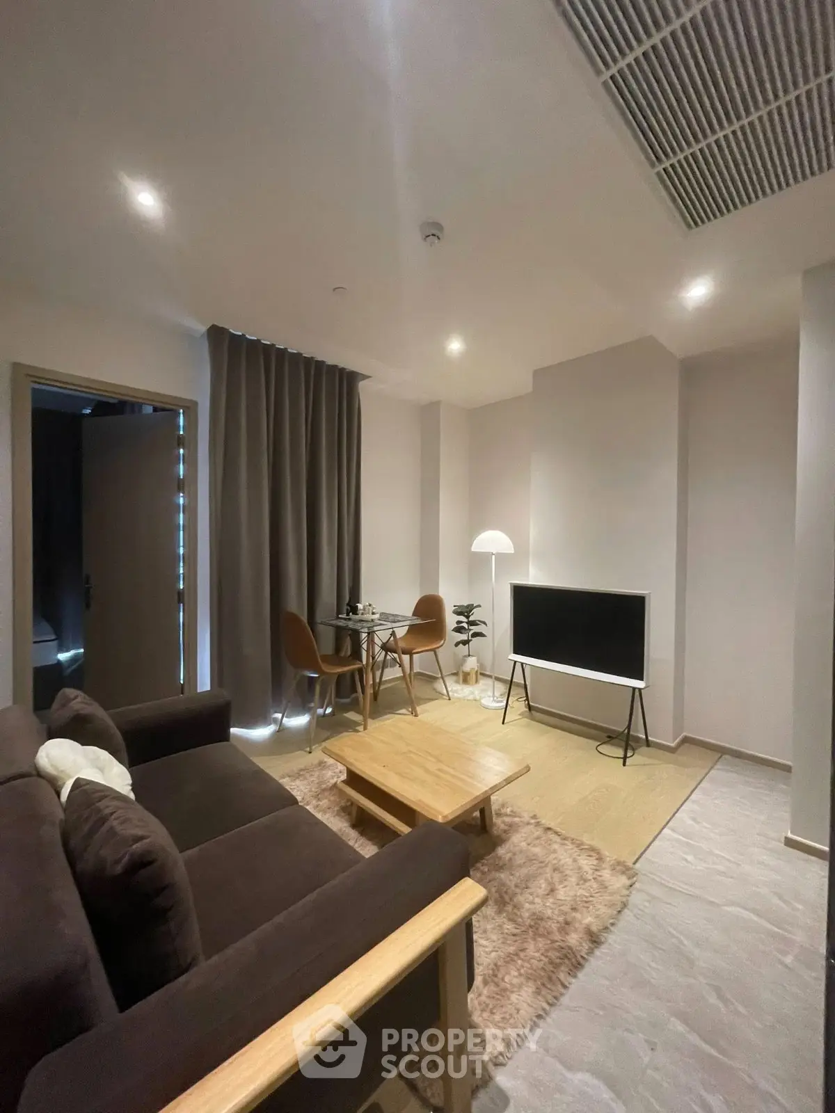 Modern living room with cozy seating, stylish decor, and ambient lighting for a comfortable lifestyle.
