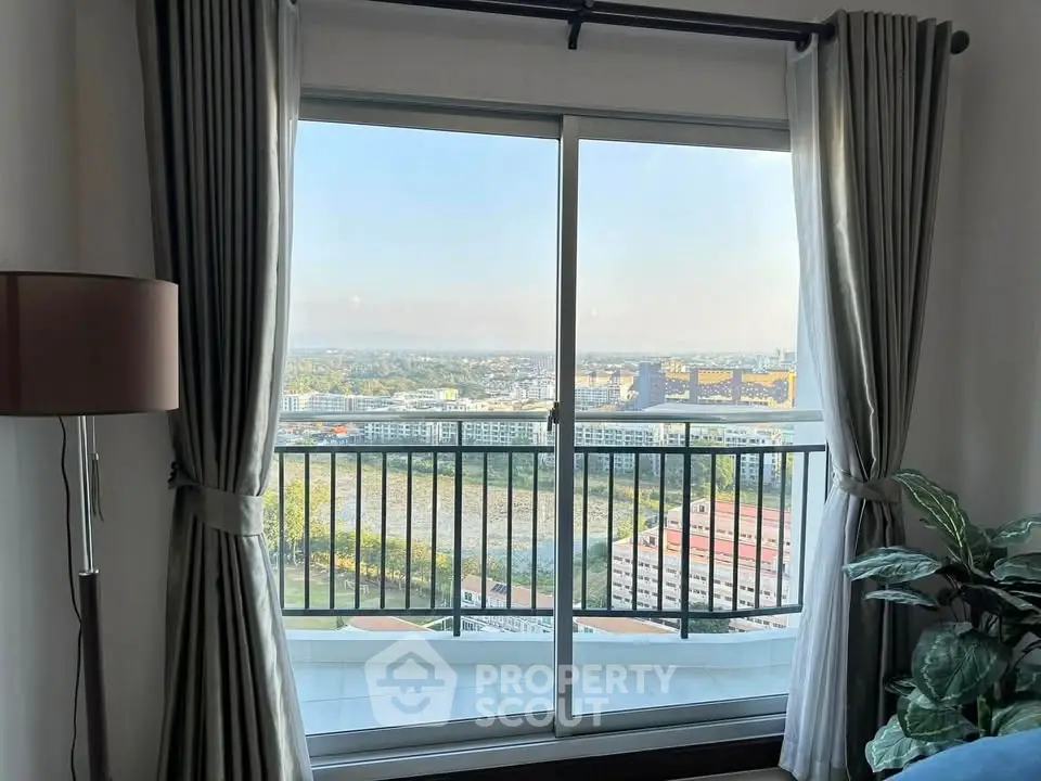 Stunning high-rise apartment with panoramic city view from balcony.