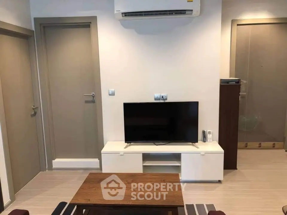Modern living room with sleek TV setup and air conditioning