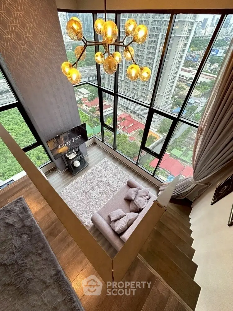 Luxurious high-rise living room with floor-to-ceiling windows and stunning city view.