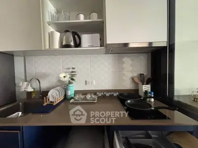 Modern kitchen with sleek design, featuring open shelving, a compact countertop, and essential appliances.