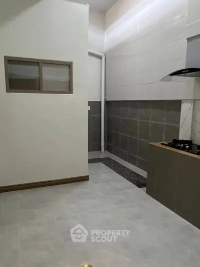 Modern kitchen with sleek design and gas stove in a contemporary home.