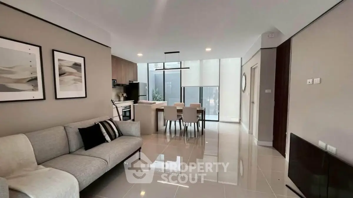 Modern open-plan living and dining area with sleek design and natural light.