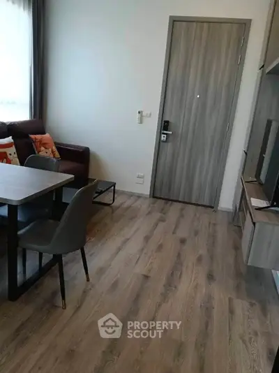 Modern living room with wooden flooring and stylish furniture in a cozy apartment.