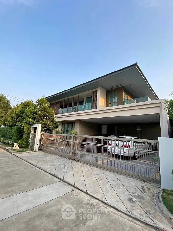 Modern two-story house with spacious driveway and lush greenery, perfect for family living.