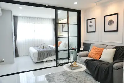 Modern bedroom with stylish decor and cozy living area in open layout