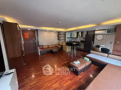 Spacious modern living room with open kitchen and stylish wooden flooring
