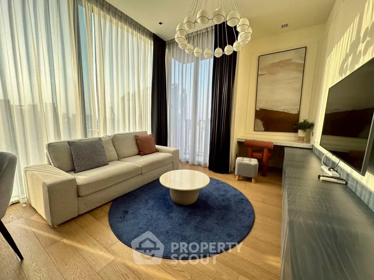 Elegant living room with modern decor, large windows, and stylish furniture in a luxury apartment.