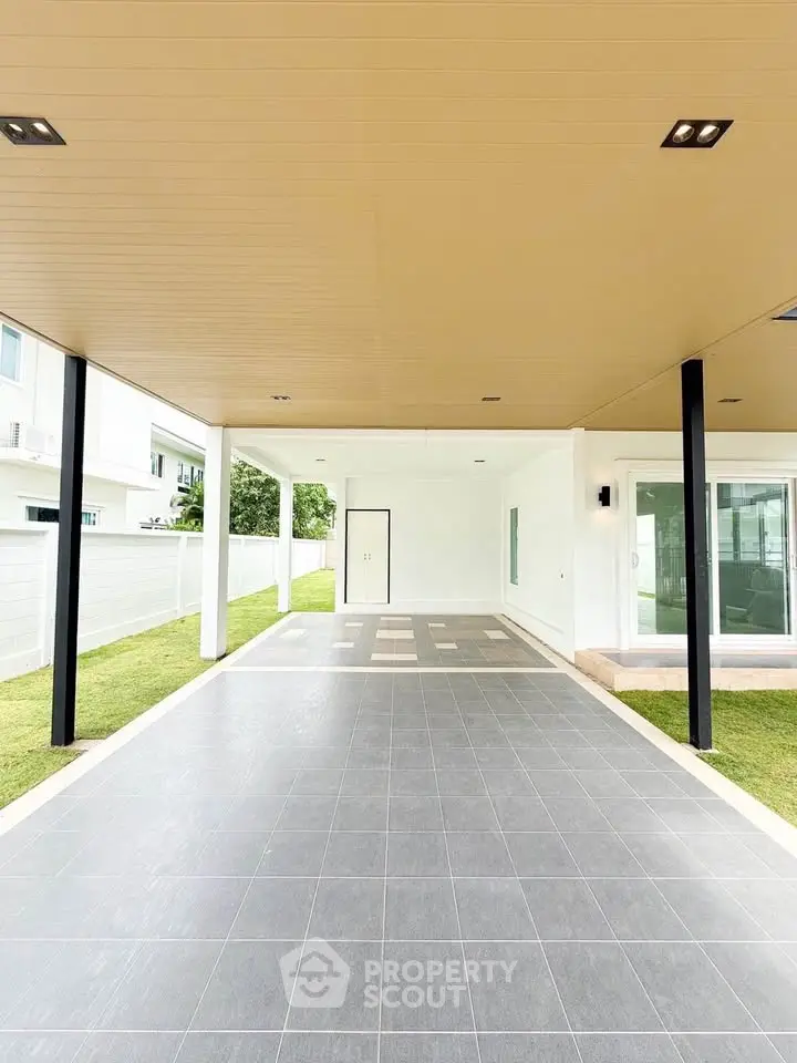 Spacious modern carport with sleek design and ample space in a contemporary home setting.
