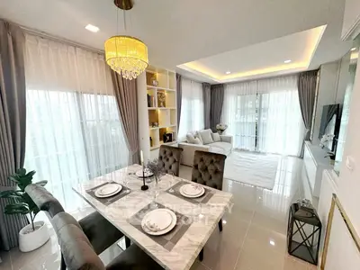 Elegant open-plan living and dining area with luxurious decor and natural light.