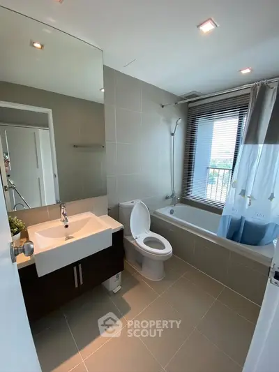 Modern bathroom with sleek fixtures and large window for natural light.