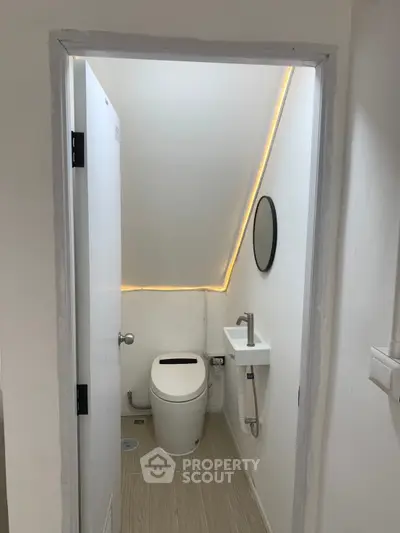 Compact modern bathroom with sleek fixtures and ambient lighting