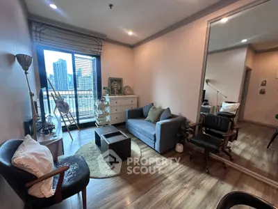 Chic living room with city view, stylish furniture, and natural light in modern apartment.