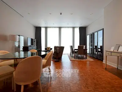 Spacious modern living and dining area with elegant parquet flooring and natural light.